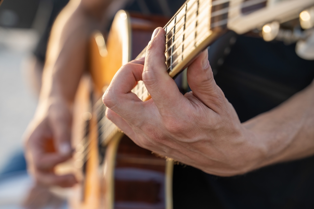 Close-up,Of,A,Musicians,Hands,Playing,An,Acoustic,Guitar.,Passion